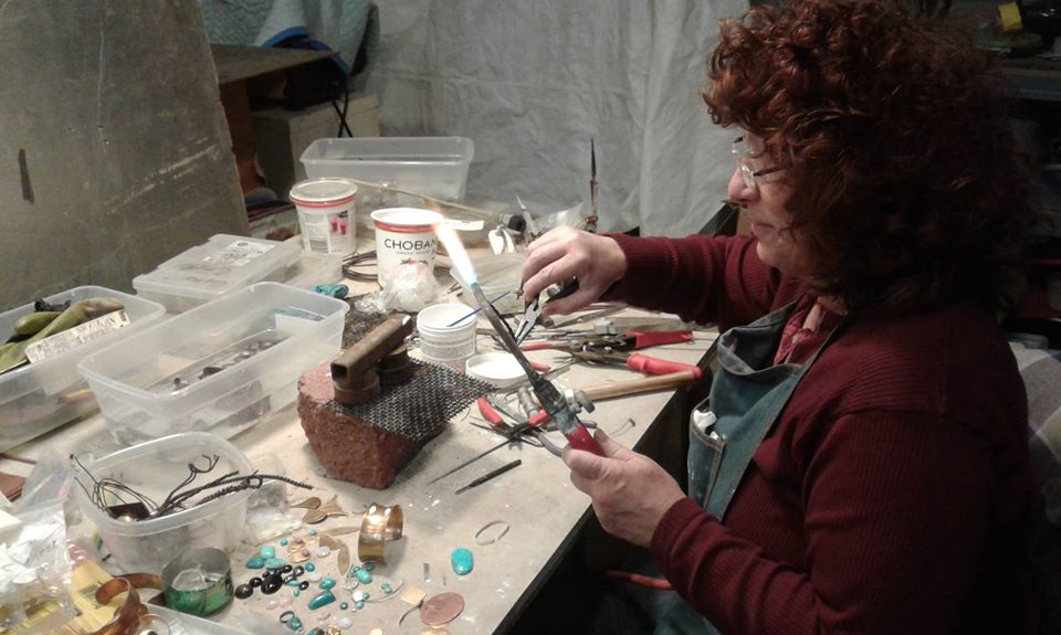 Nora Swanson makes jewelry in her studio in Berea, Kentucky. She created the social enterprise Kinetic Soul Food for Appalachian women 