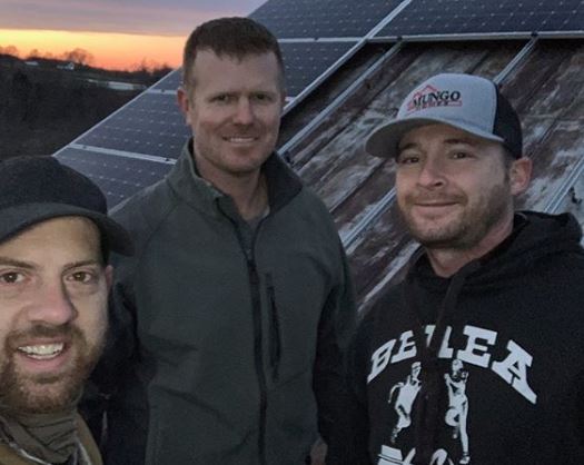 Bryce Baumann and two friends after they completed the solar panel installation on the barn of Lazy Eight Stock Farm in Paint Lick, KY.