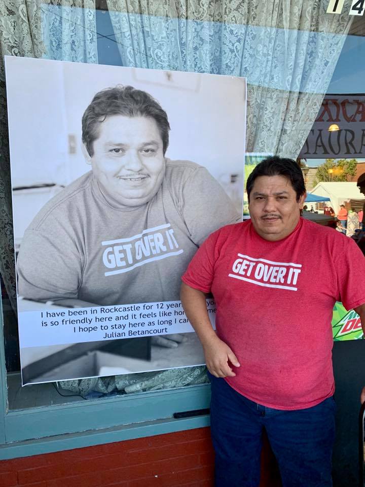 A business owner stands with his portrait in downtown mount vernon, kentucky. The Bittersweet photo project was to promote the eastern ky town