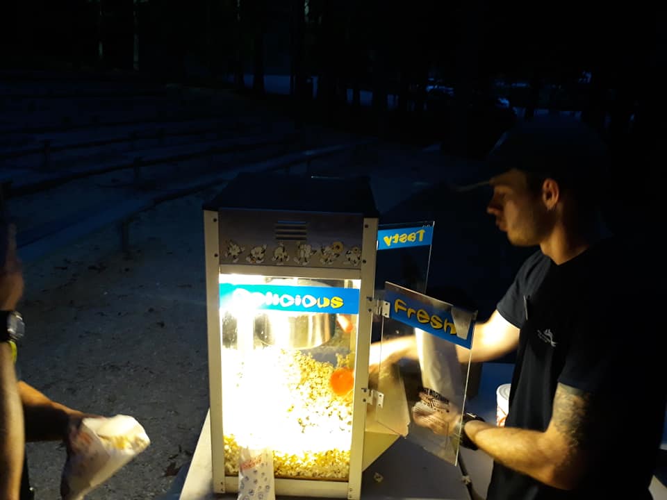 A state park employee serves popcorn in a dark cave at Carter Caves in Carter County Kentucky. The cave-in movie nights are innovative