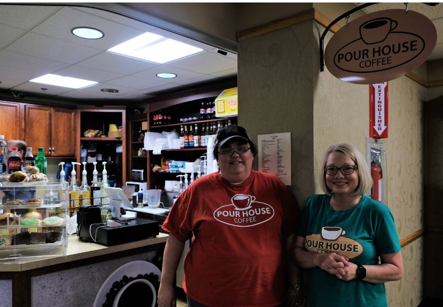 Two owners stand in front of Pour House Coffee. Kim Klien and Tiffanie Ricework own the shops partly financed by MACED business loan