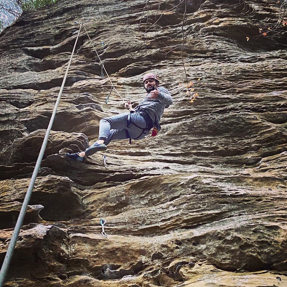 Man rappels with Southeast Mountain Guides, in the Red River Gorge, Kentucky. They are supported by a MACED business financing