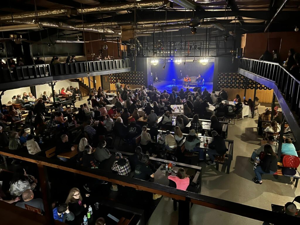 An aerial view of a crowd inside of the music venue