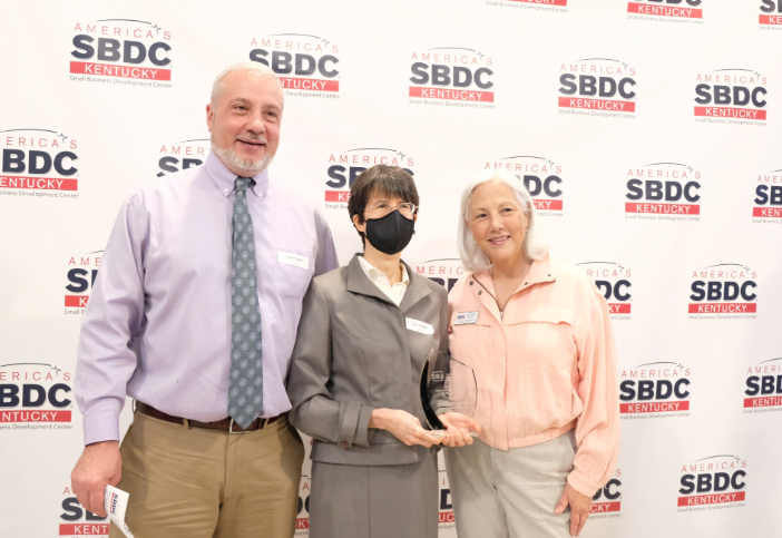 Robert Allen and Amy Williams from the Mountain Association stand with Vallorie Henderson of the Kentucky SBDC