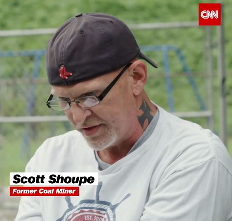 Scott sits in an interview with CNN about his experience being a coal miner who transitioned to energy efficient and renewable energy