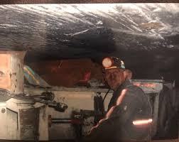 Scott Shoupe is shown underground as a coal miner. Now he works in energy efficiency and solar in Eastern Kentucky