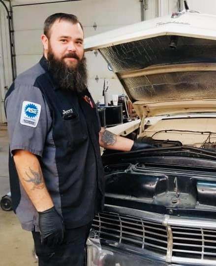 An employee at SEcond Chance Auto in Louisa, Kentucky works on a vehicle with its hood up. Addiction recovery Care started the shop.