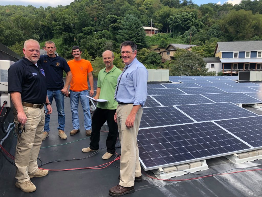 First responders in Eastern Kentucky are shown on a roof learning about how to respond to a building with solar panels.