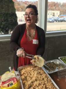 Ashley Bledsoe, a woman business owner in Harlan, serves food at an event in eastern kentucky.