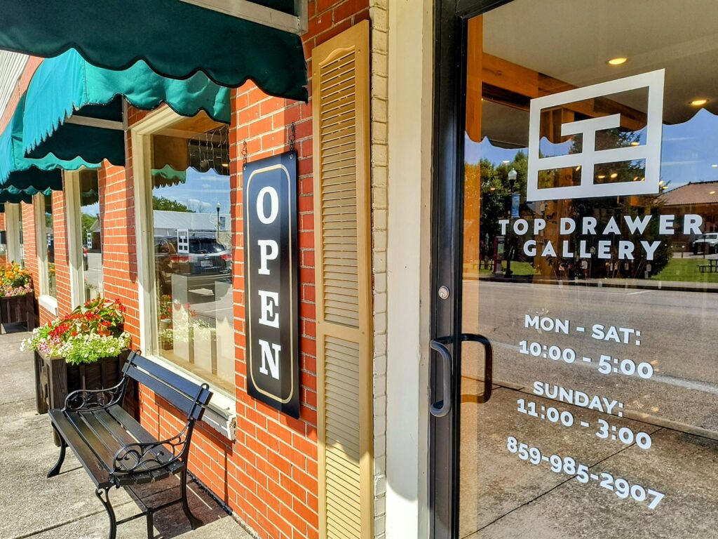 top drawer gallery door and open sign