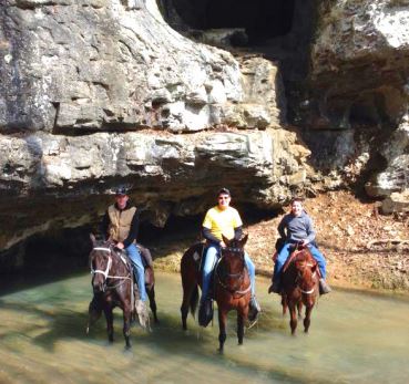 Three horseback riders stand in water in rockcastle county, kentucky. Livingston is an example of building tourism in eastern kentucky.