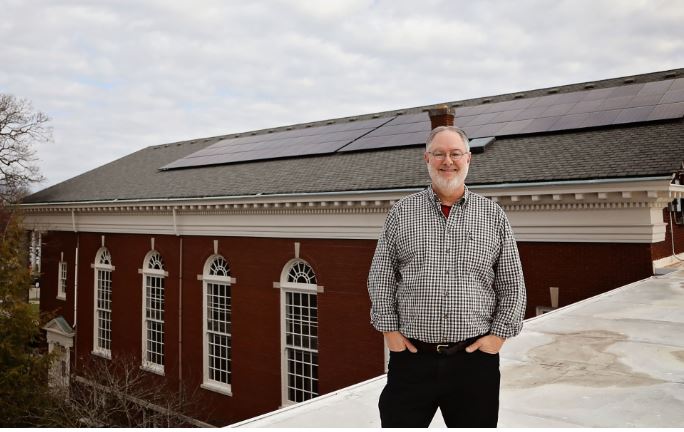 Union Church employee stands in front of the solar panels on the church in Berea, Kentucky. MACED supported the church to go solar