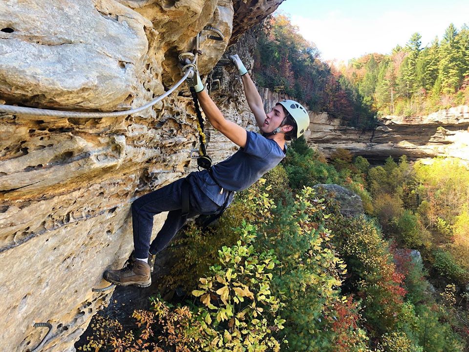 A climber on a rock wall in the Red River Gorge, Kentucky. Southeast Mountain Guides is supported by a MACED business loan
