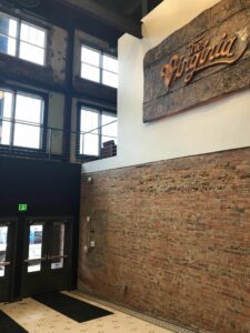 A picture of the inside of Virginia theater with exposed brick and windows.