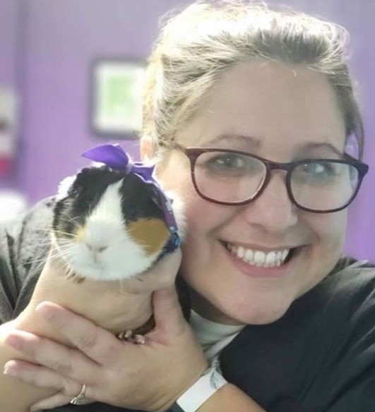 Pet groomer holds a guinea pig at her woman owned business, Waggin Tails, in letcher county, kentucky.