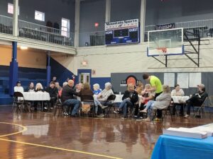 People sit in the community gym at tables