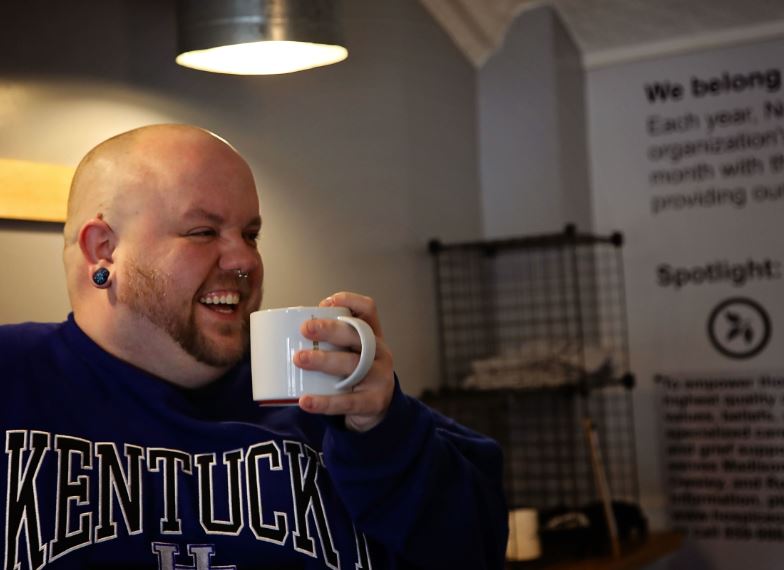 Wil Bayne, longtime employee of Noodle Nirvana, sips a drink inside the berea, kentucky restaurant business.